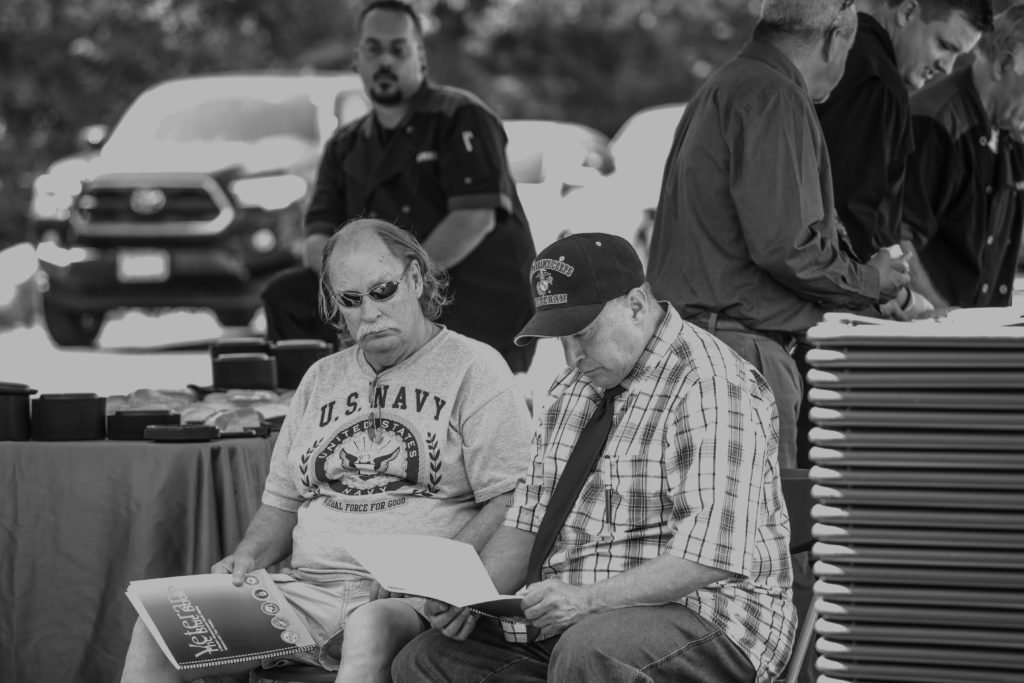 Tom Glassmire (left) sitting with Chris "Cappy" Leos at the June 29th Gordon H. Mansfields Veterans Community dedication ceremony in Leeds, MA.